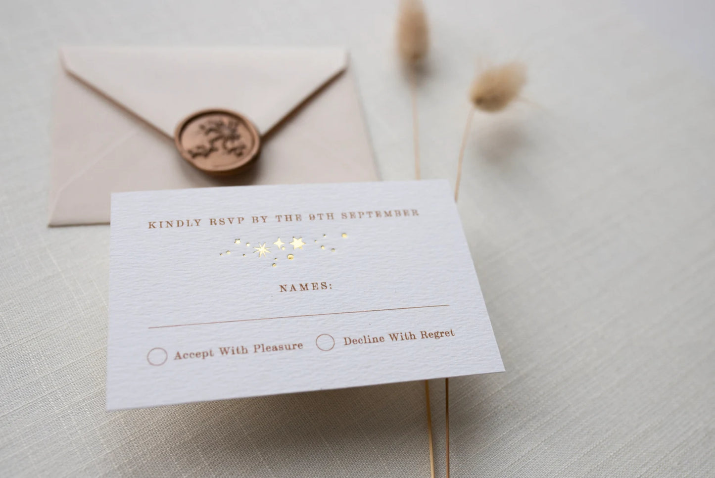 Celestial themed wedding RSVP. A truly magical cluster of lots of little stars is hot foiled onto thick textured card, styled with almond coloured envelopes. Fancy Folk Design