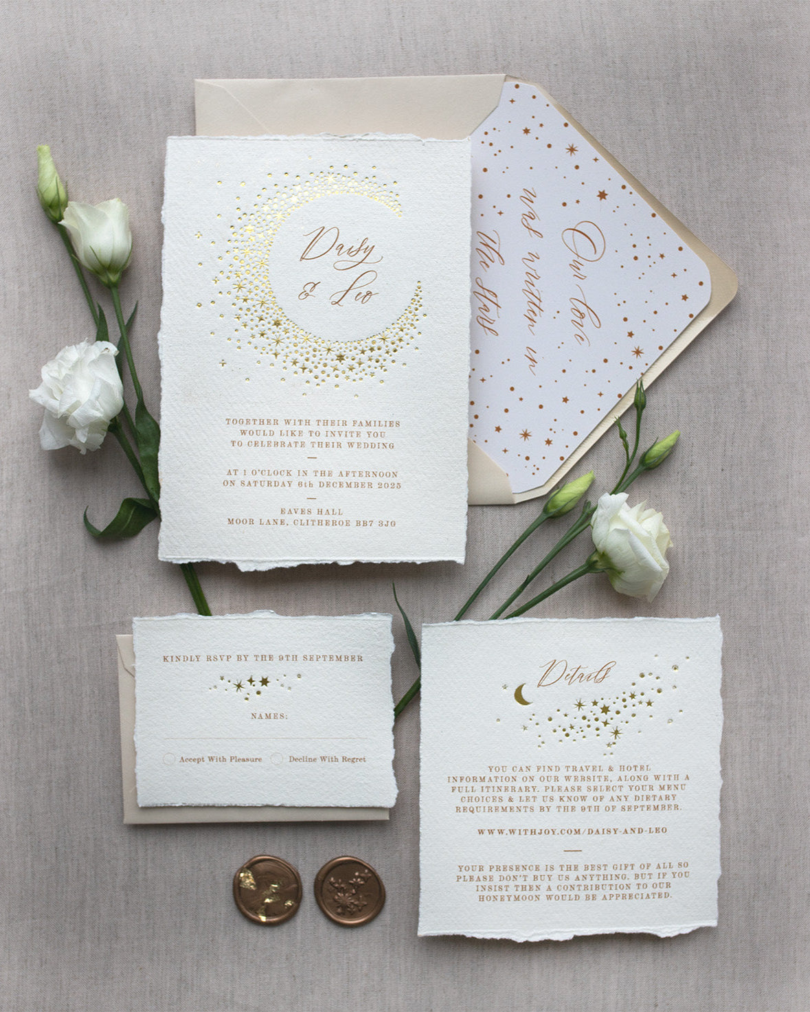 Celestial themed wedding stationery suite laid out in a flat lay format. A truly magical crescent moon design made up of lots of little stars is hot foiled in gold on to the main invitation. Smaller cluster of gold stars feature on the details card and RSVP. The invitations are foiled and printed onto tactile handmade paper with a torn romantic edge. Styled with gold wax seals, neutral envelopes with a luxury envelope liner which reads "Our love was written in the stars". FancyFolk Design