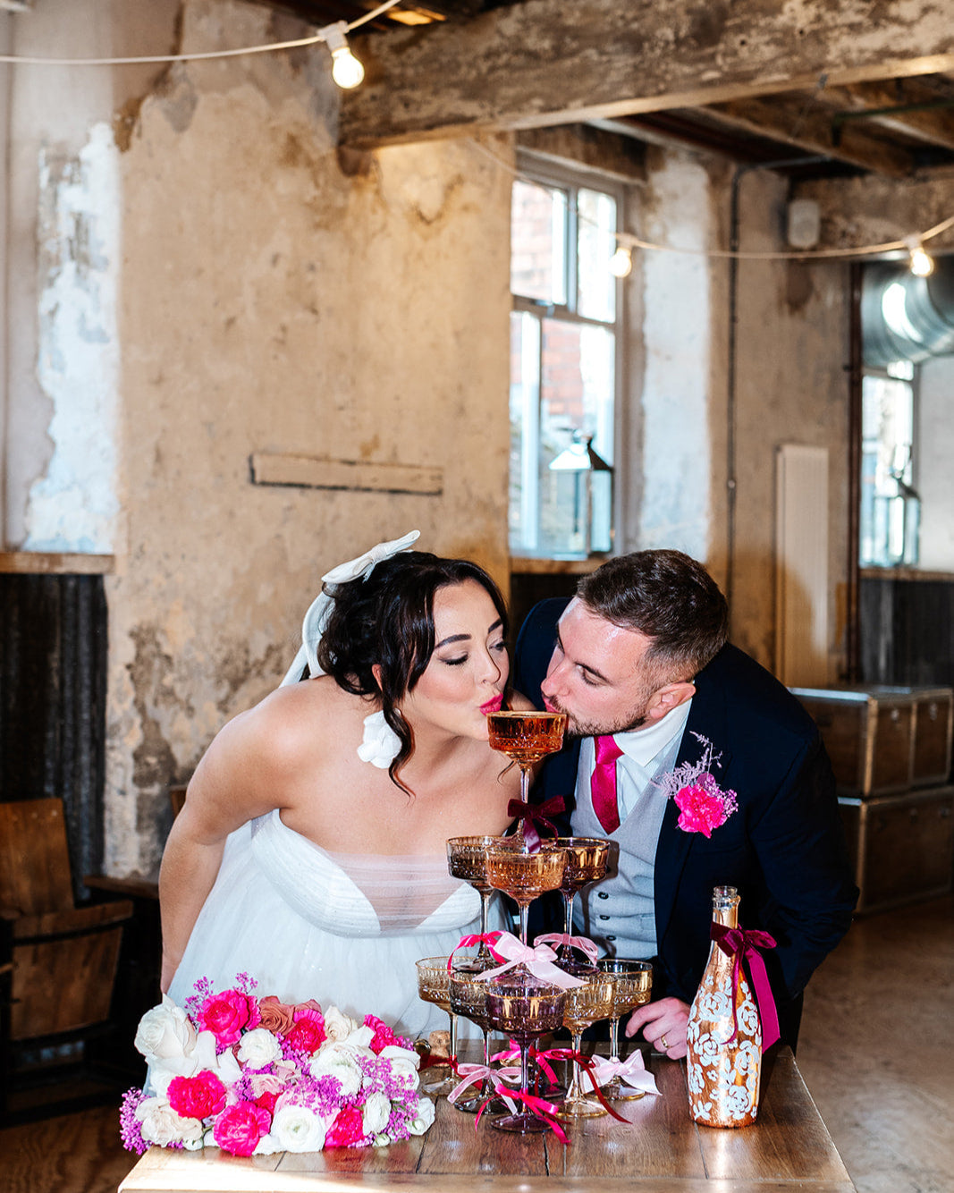 with white painted roses all around the bottle. Personalise label with couples names and wedding date. Perfect for a Champagne Tower moment. By Fancy Folk Design