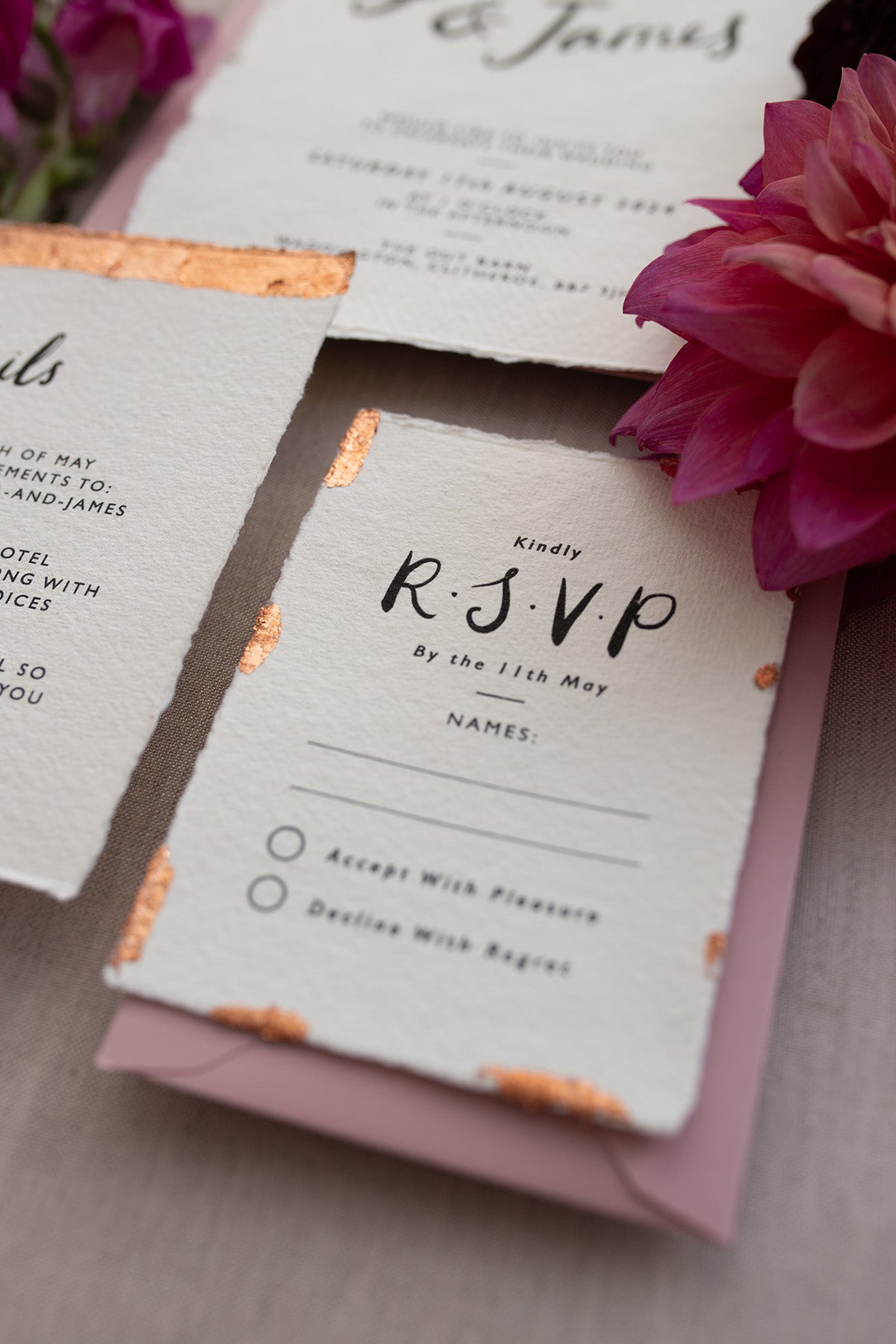 Modern Calligraphy Wedding RSVP. Our wedding stationery features a beautiful hand lettered calligraphy design and are printed on textured handmade Indian paper with hand torn edges for a soft romantic feel. Each piece is lovingly hand finished with copper leaf for a luxury feel. Styled with dusky pink envelopes. Fancy Folk