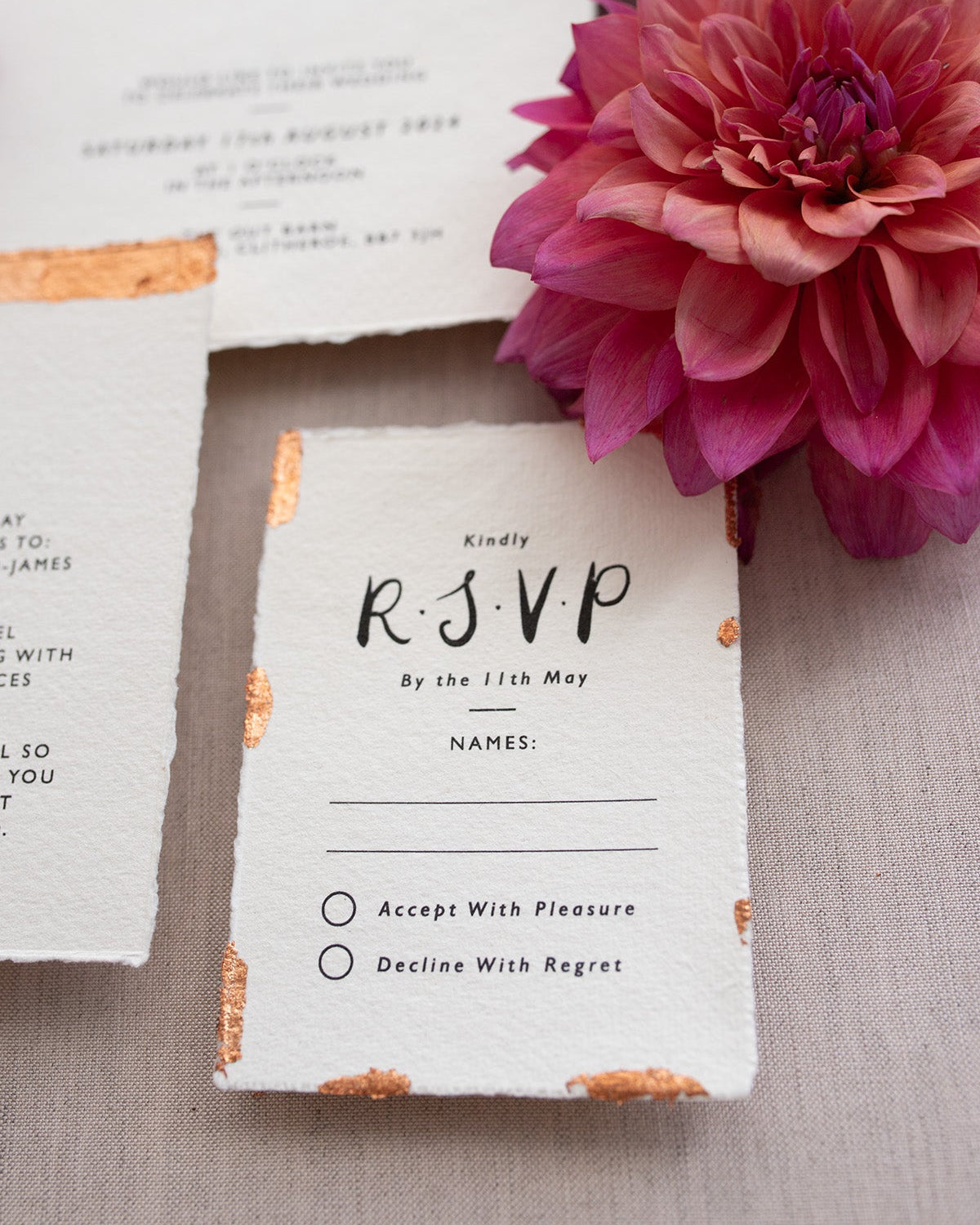 Modern Calligraphy Wedding RSVP. Our wedding stationery features a beautiful hand lettered calligraphy design and are printed on textured handmade Indian paper with hand torn edges for a soft romantic feel. Each piece is lovingly hand finished with copper leaf for a luxury feel. Styled with burgundy and coral florals, perfect for autumn and winter weddings. Fancy Folk