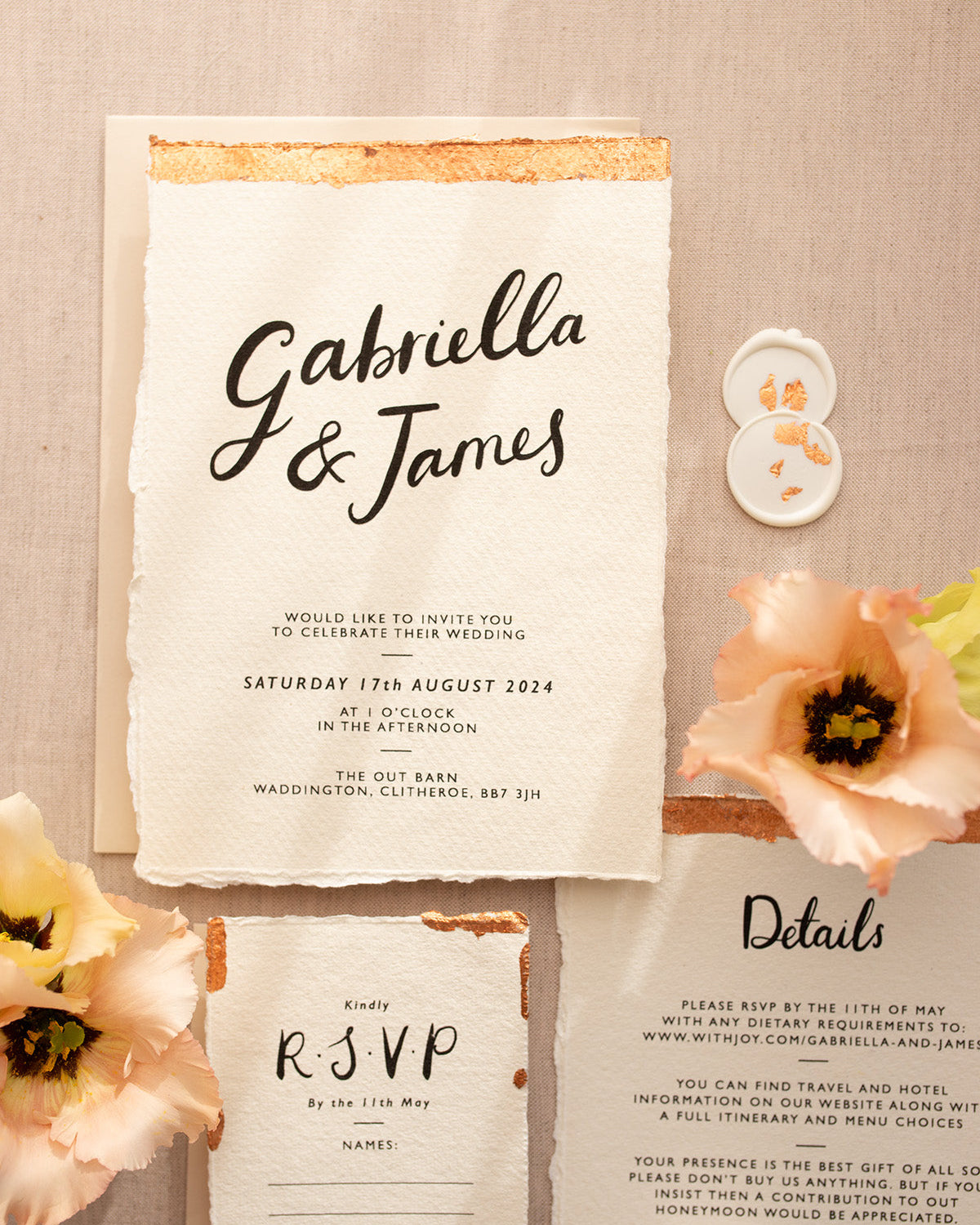 Modern Calligraphy Wedding Invitation, Details Card and RSVP with neutral almond coloured envelopes. Our wedding stationery features a beautiful hand lettered calligraphy names design printed on textured handmade Indian paper with hand torn edges for a soft romantic feel. Each piece is lovingly hand finished with copper leaf for a luxury feel. Styled with white and copper leaf wax seals and peachy florals. Fancy Folk
