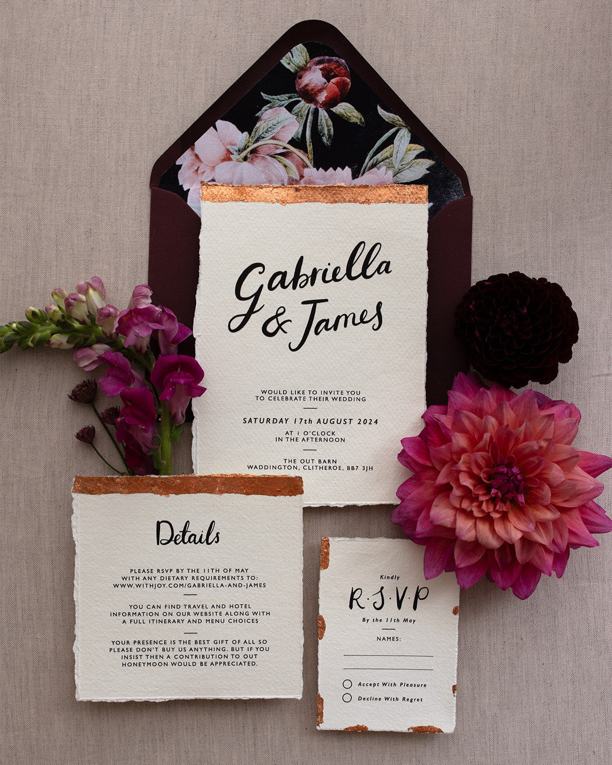 Modern Calligraphy Wedding Invitation, Details Card and RSVP with rich burgundy coloured envelopes. Our wedding stationery features a beautiful hand lettered calligraphy names design printed on textured handmade Indian paper with hand torn edges for a soft romantic feel. Each piece is lovingly hand finished with copper leaf for a luxury feel. Styled with burgundy and coral florals, perfect for autumn and winter weddings. Fancy Folk