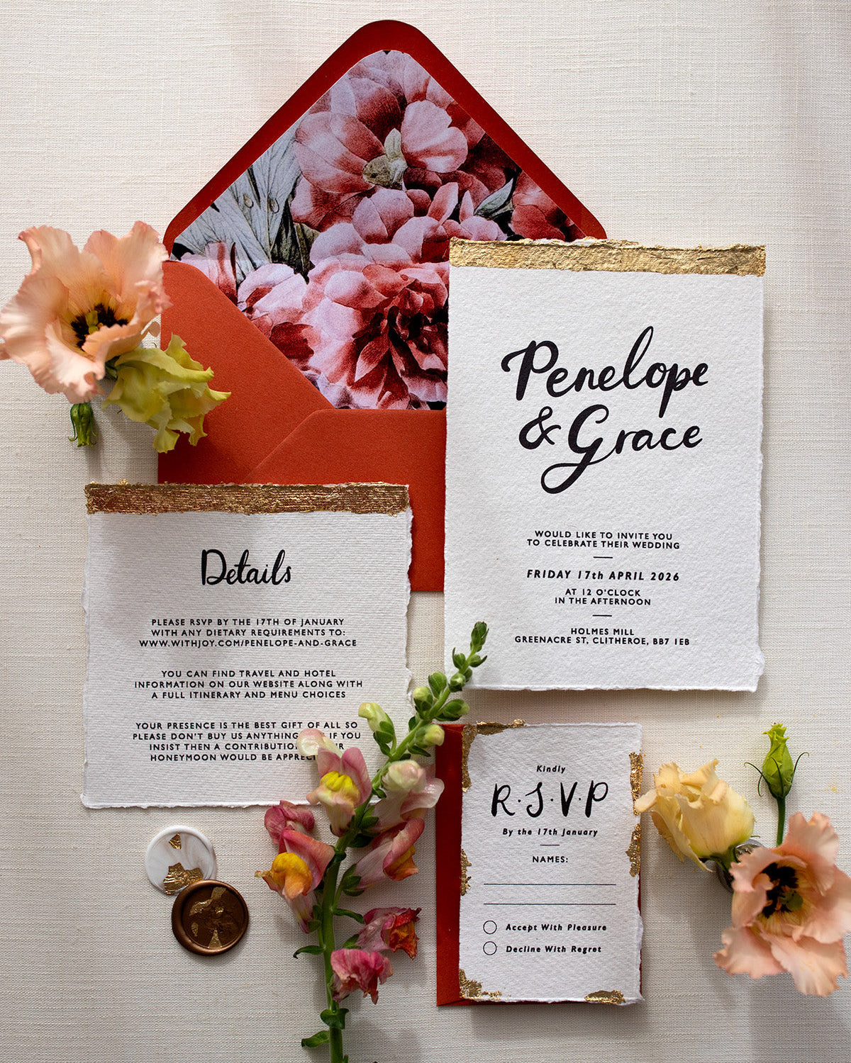 Modern Calligraphy Wedding Invitation, Details Card and RSVP with terracotta coloured envelopes. Our wedding stationery features a beautiful hand lettered calligraphy names design printed on textured handmade Indian paper with hand torn edges for a soft romantic feel. Each piece is lovingly hand finished with gold leaf for a luxury feel. Styled with white and gold leaf wax seals and peachy florals. Fancy Folk