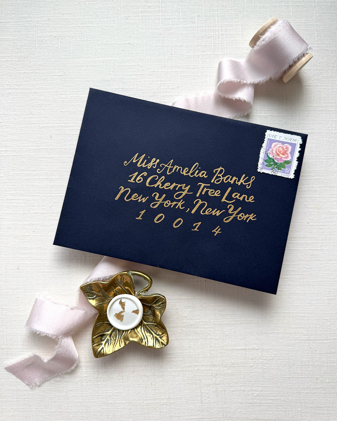 Wedding envelope calligraphy names and address in a old ink. Written on a navy blue envelope. Fancy Folk
