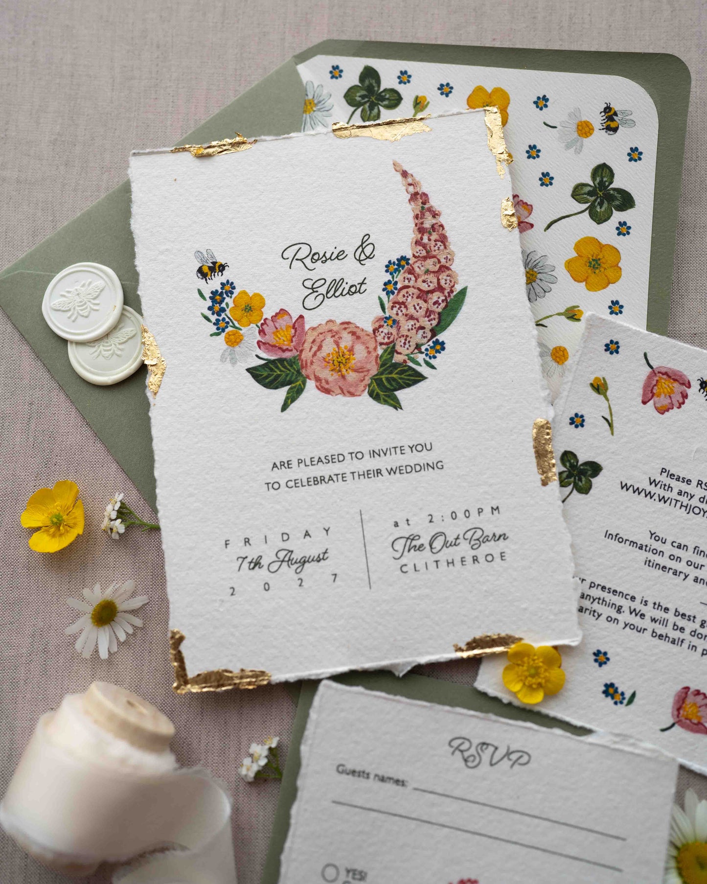 Watercolour hand painted florals of meadow flowers and a little bee make up a posy. Couples named are nestle in the floral. Printed on handmade Indian cotton paper with gold leaf accent. Styled with white bee wax seals, floral envelope liners and silk ribbon. Sage green envelops and fresh flowers.