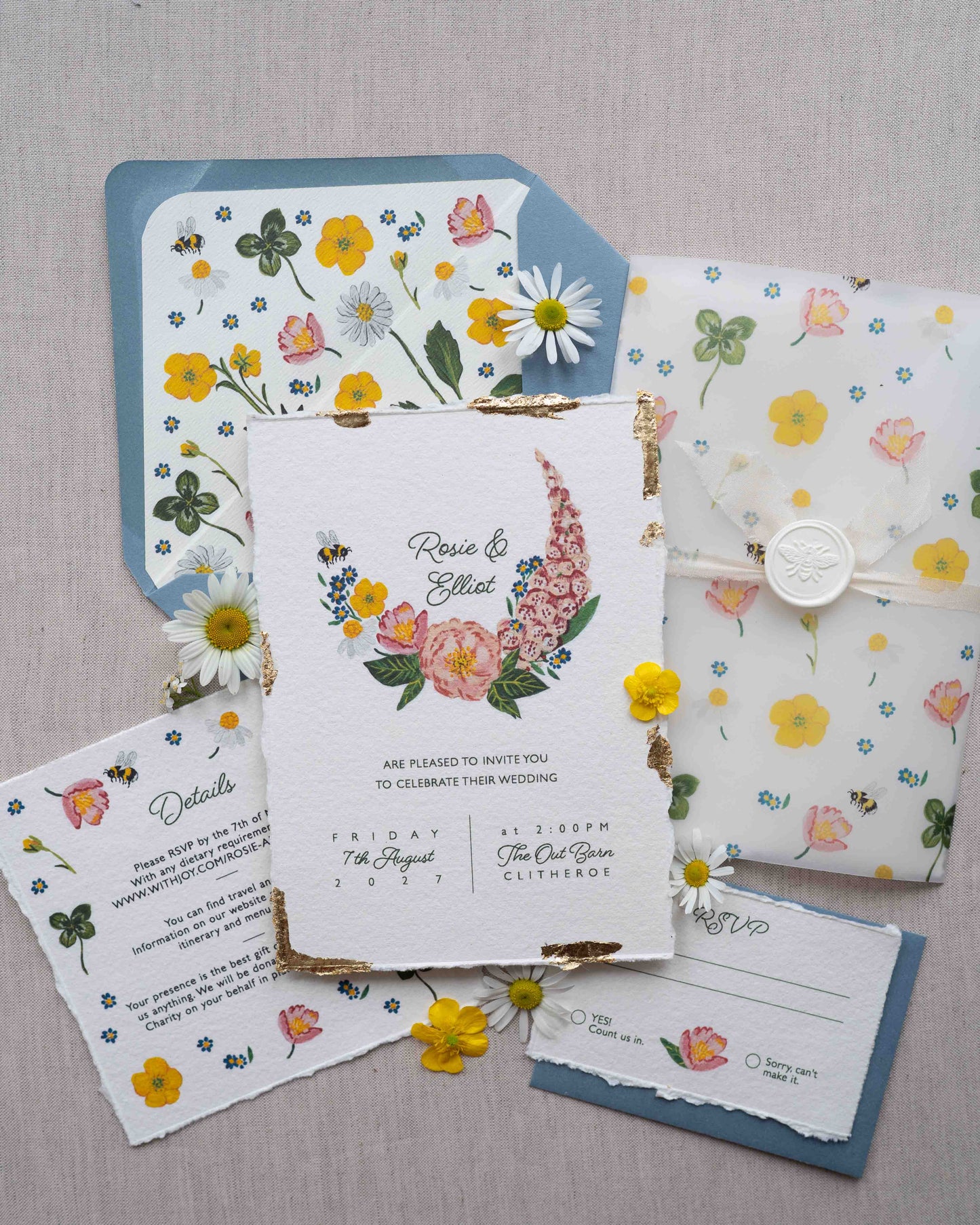 Watercolour hand painted florals of meadow flowers and a little bee make up a posy. Couples names are nestled in the floral. Printed on handmade Indian cotton paper with gold leaf accent. Full suite including details and rsvp cards. Styled with white bee wax seals, floral envelope liners and silk ribbon. Dusty blue envelopes, floral vellum wrap tied with silk ribbon.