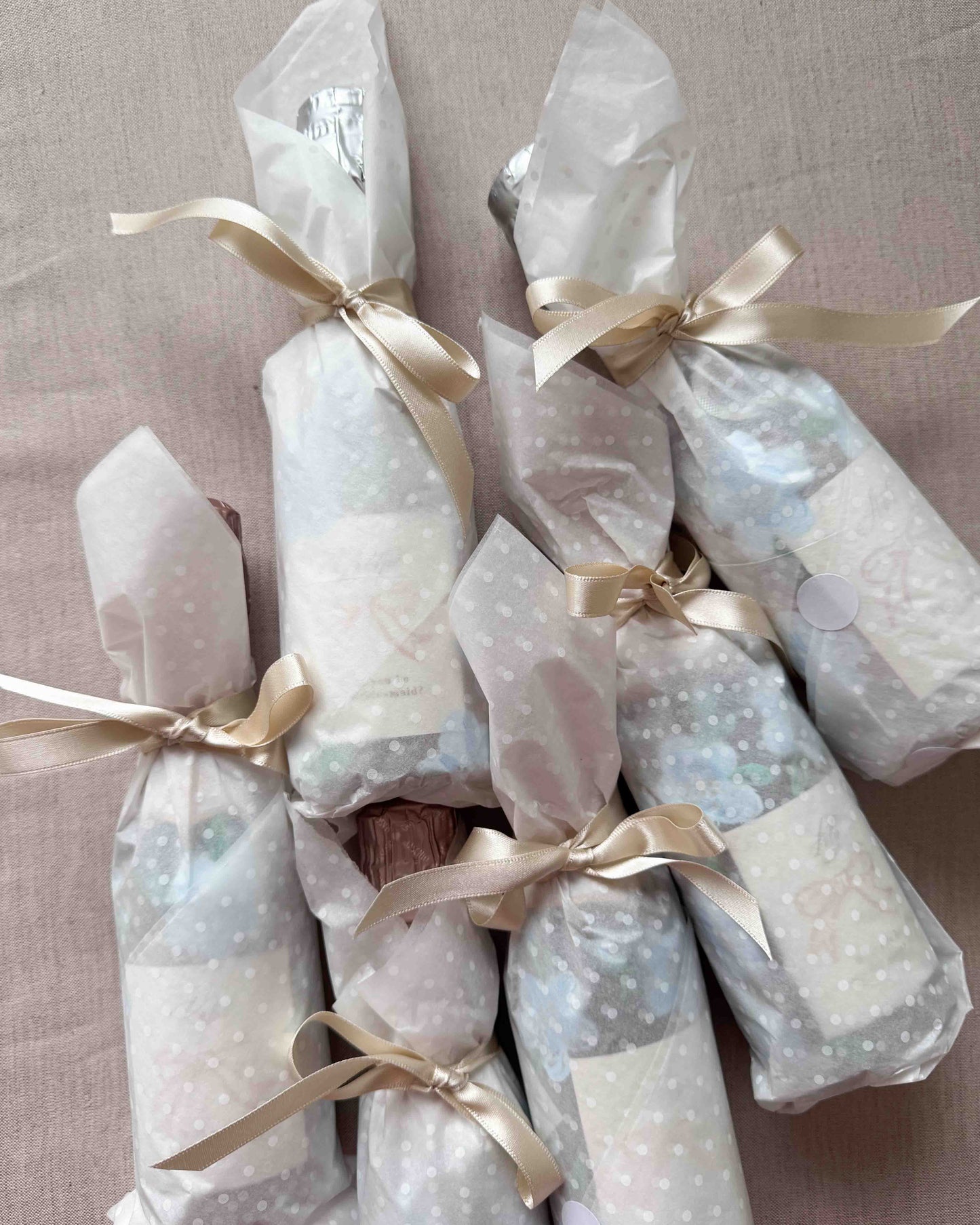 Set of mini bottles with hand painted blue florals and personalised labels. Beautifully gift wrapped in white spotty tissue paper and ties with a ribbon.