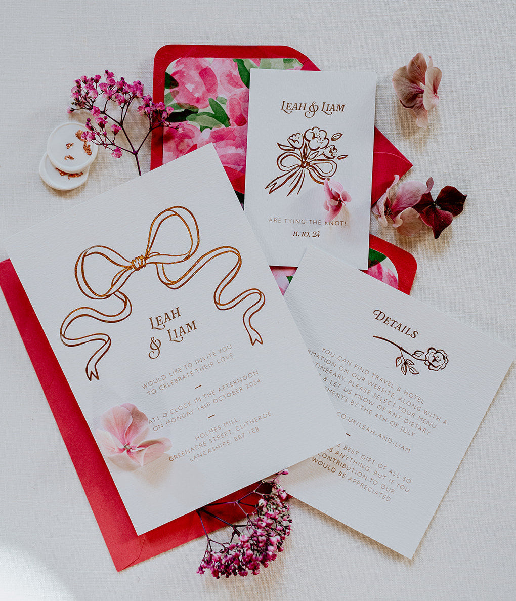 Bow Wedding Invitation Suite. Featuring an elegant Rose Gold Hot Foil Bow for modern couples. Paired with hot pink envelopes and hand painted roses envelope liners. Save the date, details card, RSVP, wax seals & envelope liners..