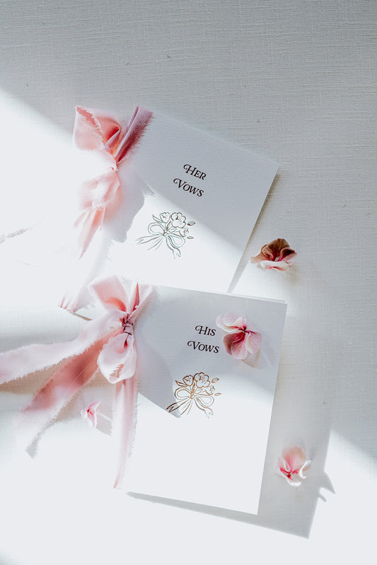 Beautiful hot foil wedding vow books with bow and posy design, couples names and wedding date. Hand finished with blush silk ribbon tied in a bow