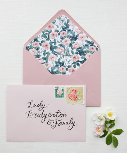 Wedding envelope calligraphy names and address in a black ink. Written on a pink envelope. Fancy Folk