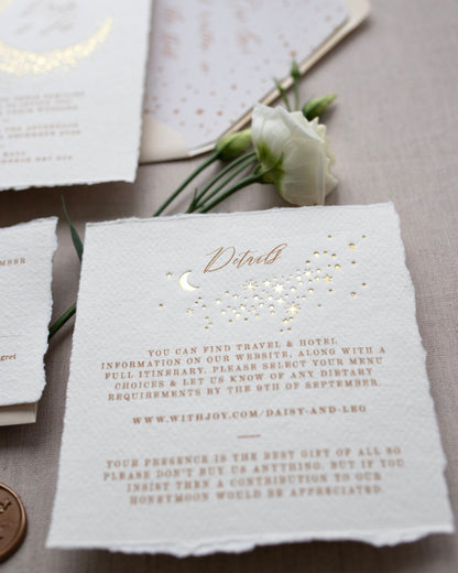 Celestial themed wedding details card. A truly magical scatter of little stars is hot foiled in gold on onto tactile handmade paper with a torn romantic edge. FancyFolk Design