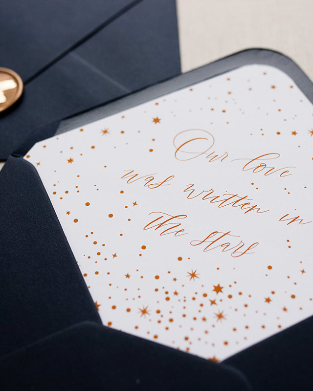 Celestial envelope liner inside a navy blue envelope. Elevate your wedding stainer with this luxury night stars design, wording ready "Our love was written on the stars". Fancy Folk Design