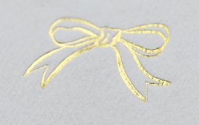 Gold Foil Bow wedding place card close up.Designed by Facy Folk wedding stationery