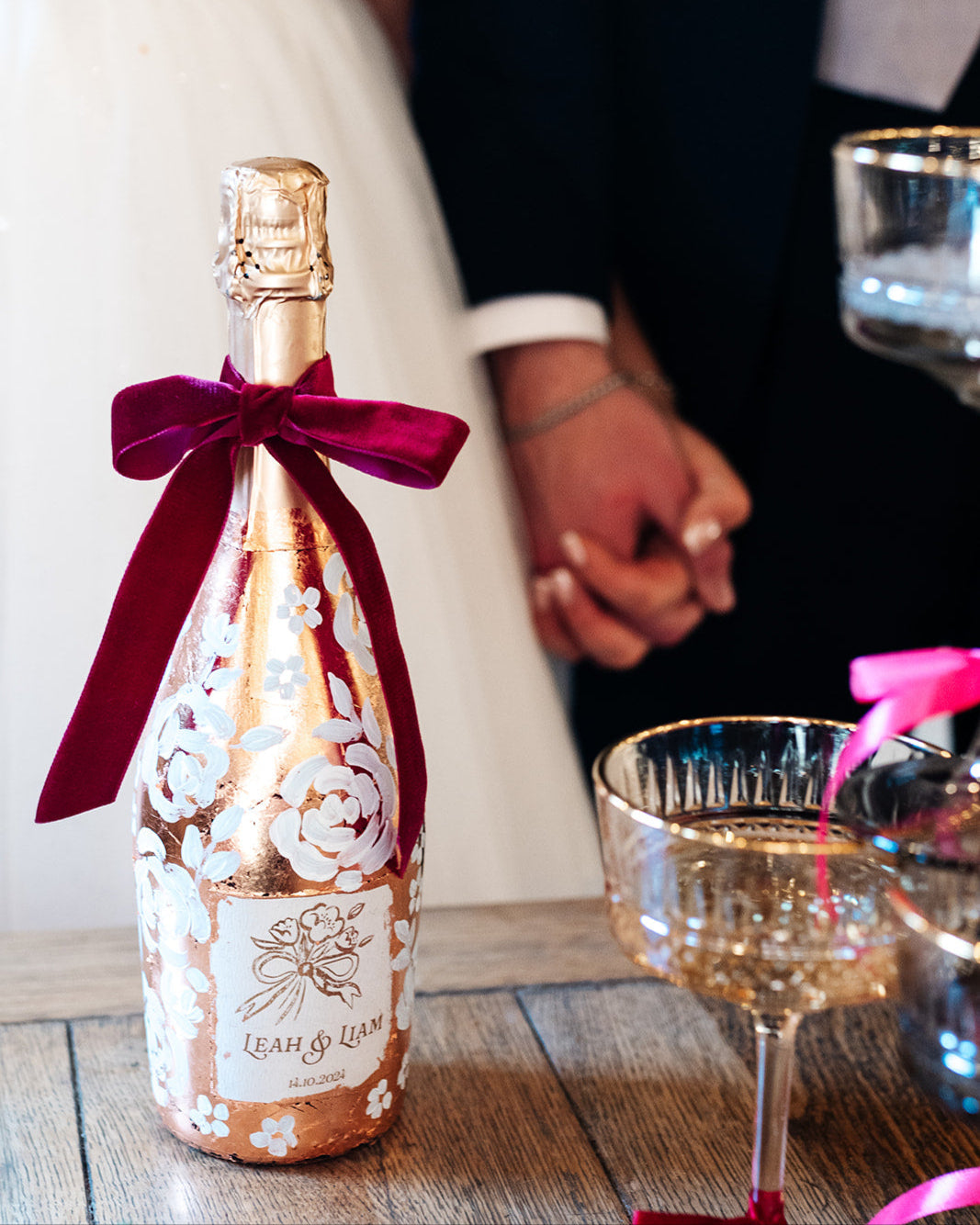 with white painted roses all around the bottle. Personalise label with couples names and wedding date. Perfect for a Champagne Tower moment. By Fancy Folk Design