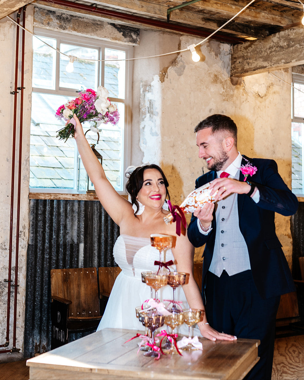 with white painted roses all around the bottle. Personalise label with couples names and wedding date. Perfect for a Champagne Tower moment. Poured by the groom. By Fancy Folk Design
