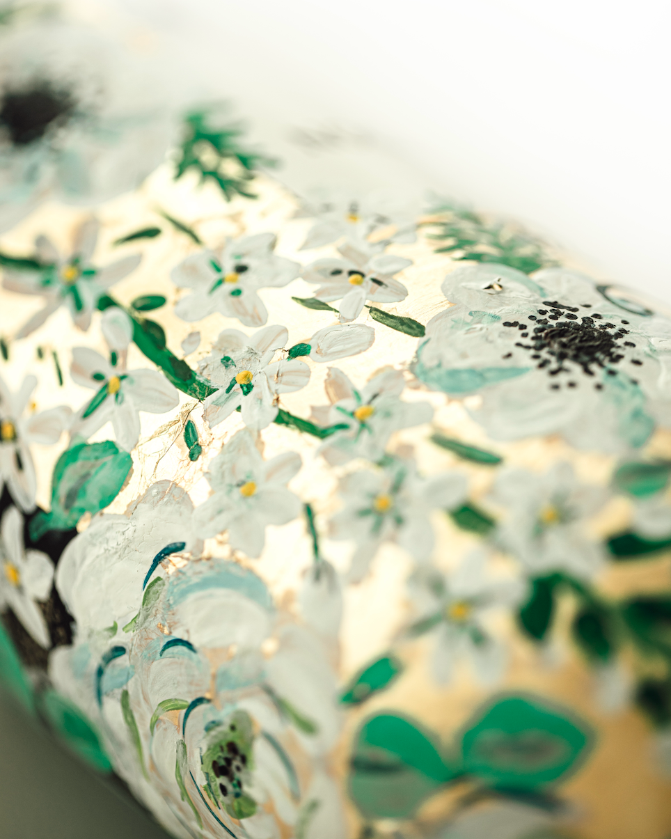 Close up of hand painted florals on a gold leaf base. Painted on a bottle of Champagne. Fancy Folk