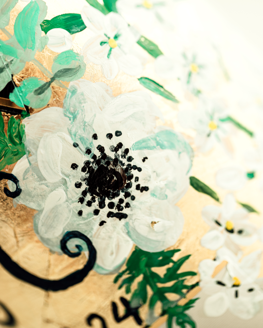 Close up of hand painted florals on a gold leaf base. Painted on a bottle of Champagne. Fancy Folk