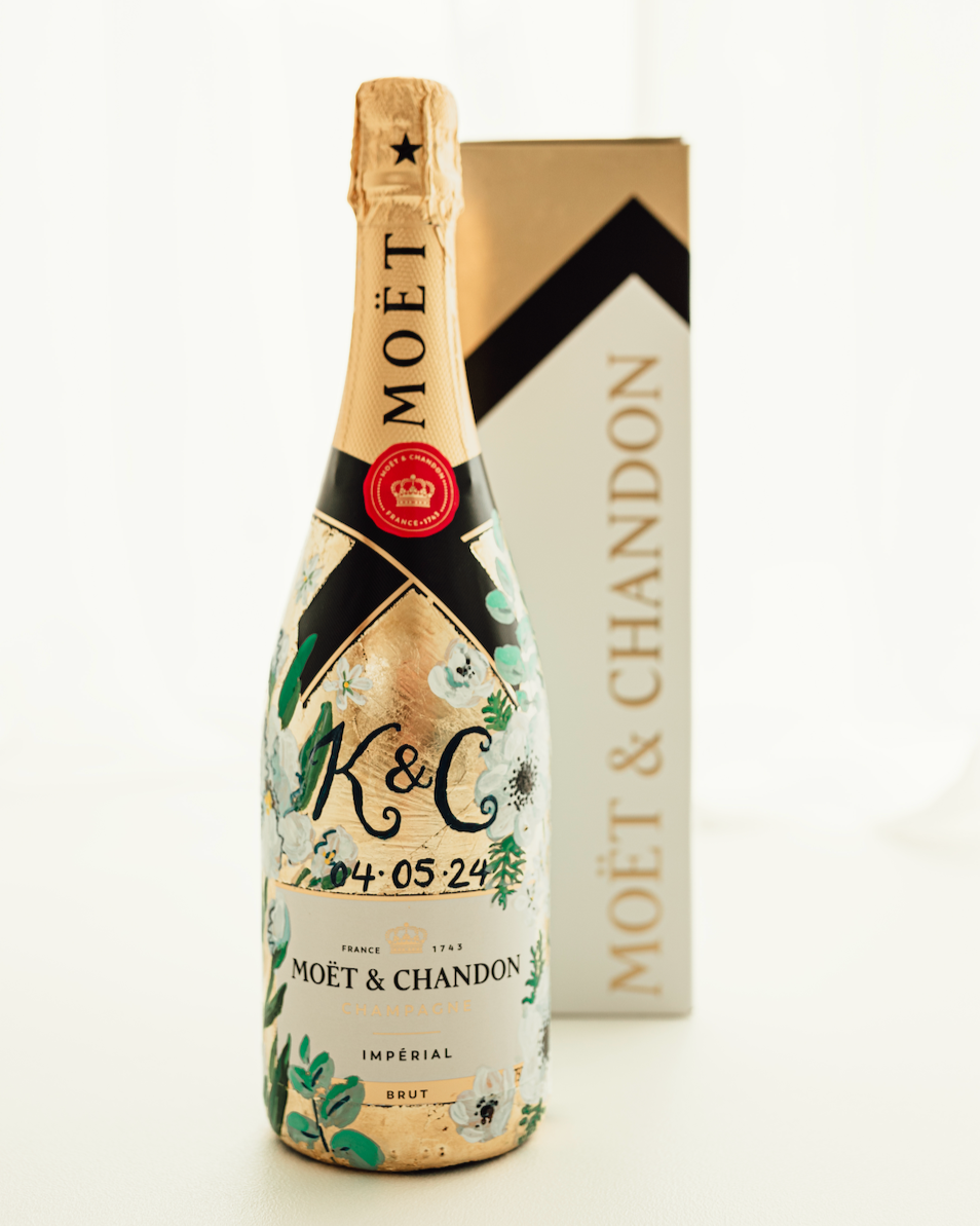 Hand painted Bottle of Moet Champagne. Perfect wedding gift with couples monogram initials and wedding date. Gold leaf base painted florals to match the bridal bouquet. Photographed with gift box. Fancy Folk Design