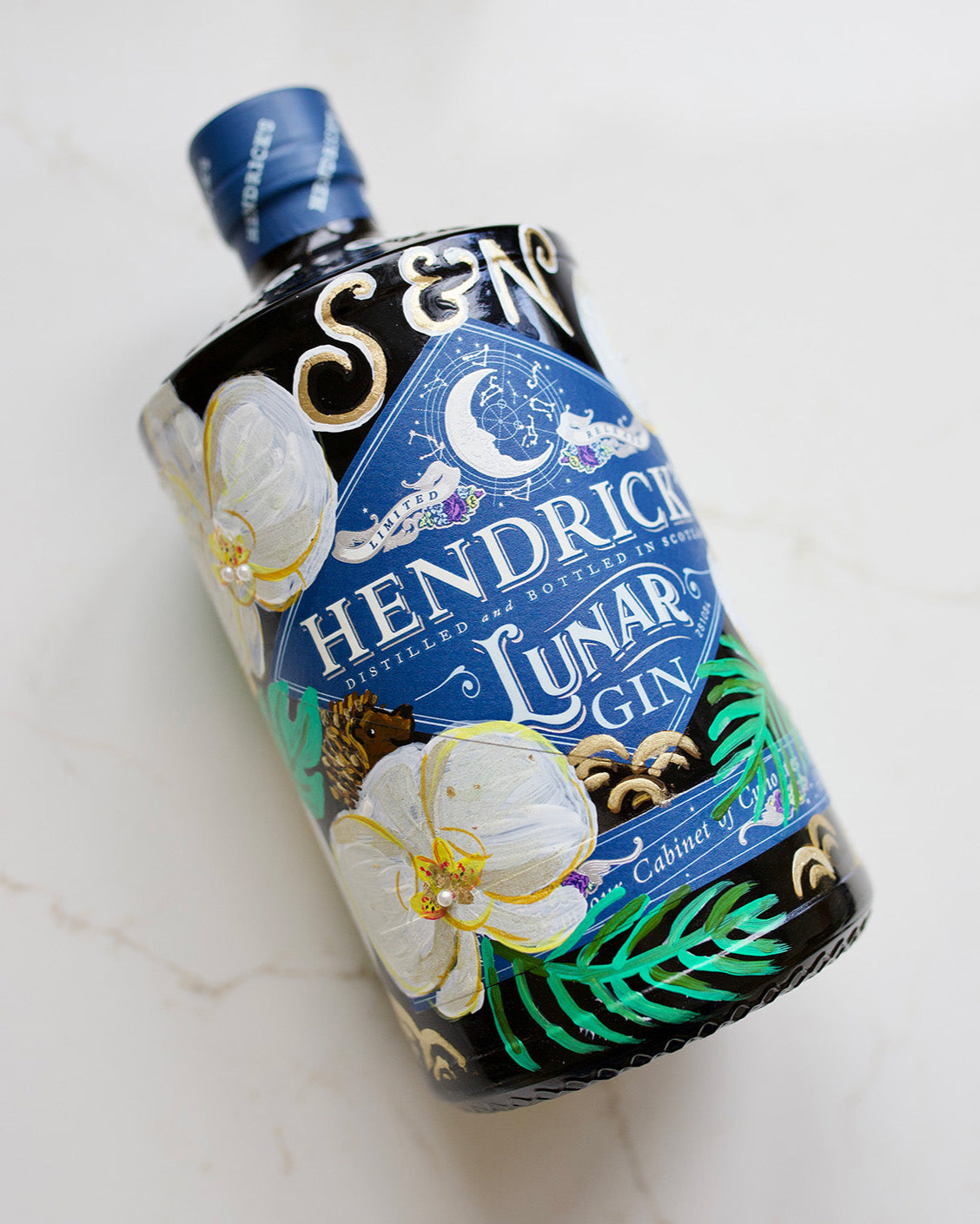 Wedding Gift. Hand painted gin bottle with orchid flowers. Embellished with gold leaf and pearls. Personalised with wedding date and couples initials. Hidden hedgehog represents a loved one.