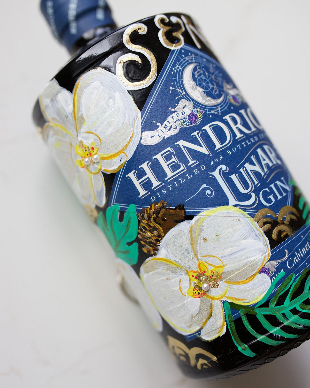 Wedding Gift. Hand painted bottle with orchid flowers. Embellished with gold leaf and pearls. Personalised with wedding date and couples initials. Hedgehog represents loved one.