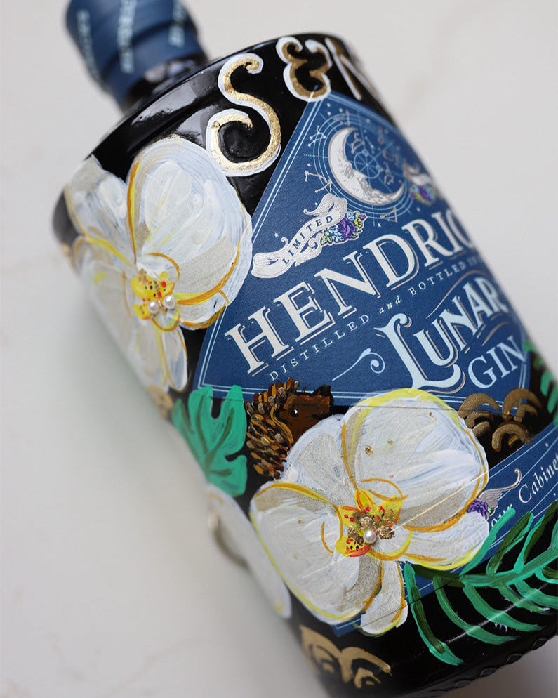 Wedding Gift. Hand painted bottle with orchid flowers. Embellished with gold leaf and pearls. Personalised with wedding date and couples initials. hidden hedgehog represents a loved one.