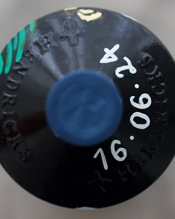 Close up of hand painted wedding date in white. On a beautifully personalised occasion bottle, wedding gift.