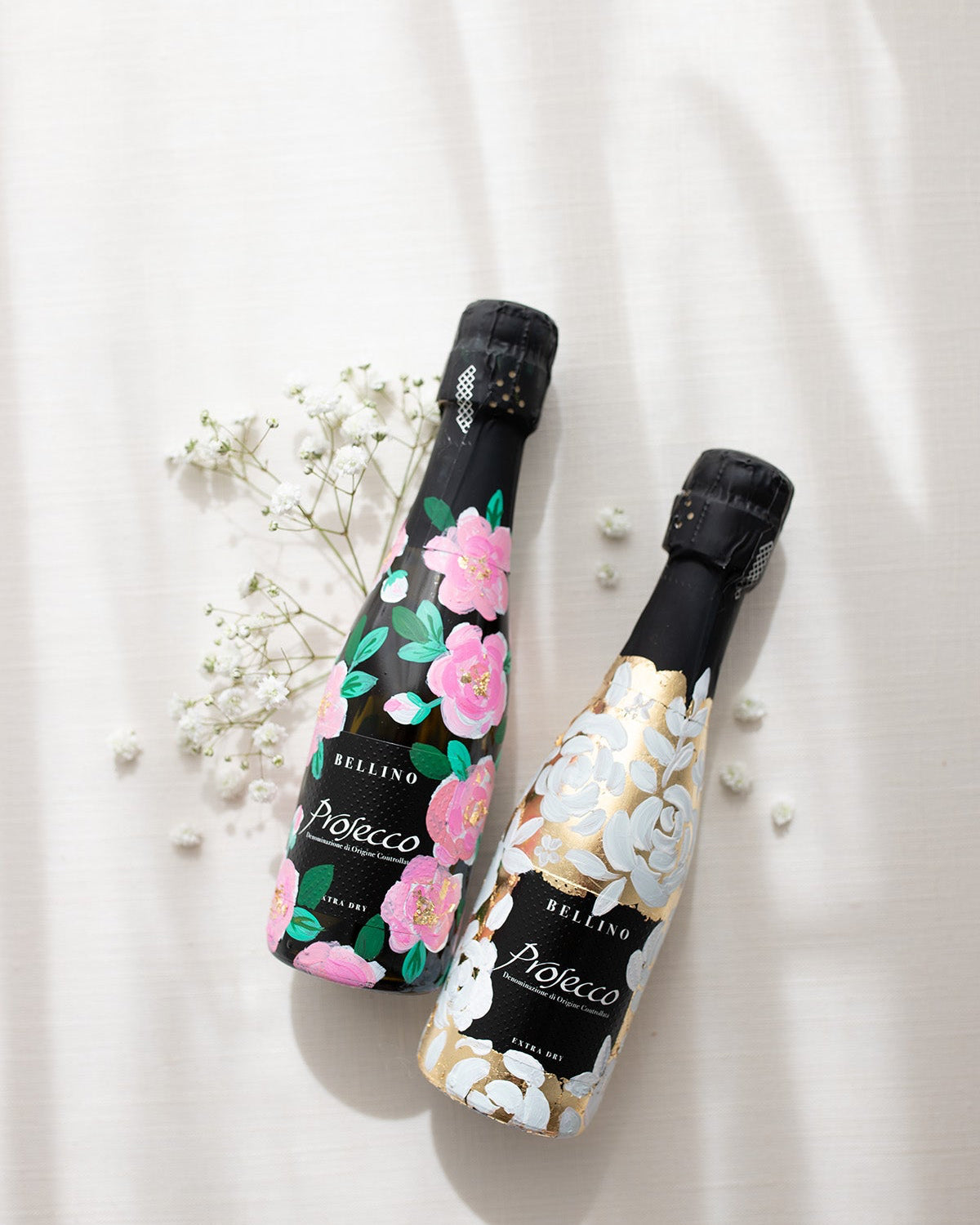 Mini bottles of Prosecco hand painted with a white roses design on a metallic gold leaf base. The perfect luxury bridesmaid proposal gift. Paired with a pink roses panted design available in a separate listing. Fancy Folk Design