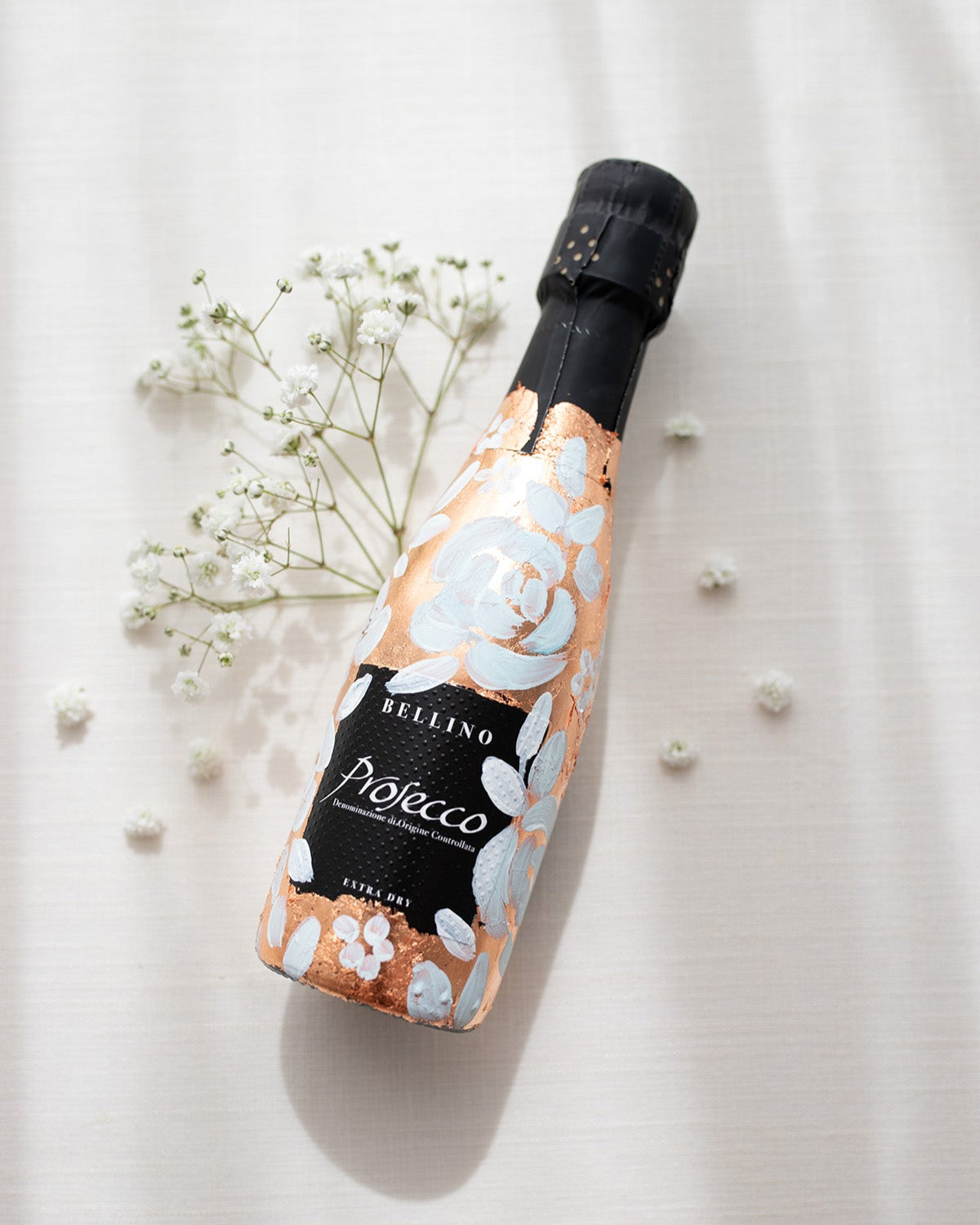 Mini bottles of Prosecco hand painted with a white roses design on a metallic copper leaf base. The perfect luxury bridesmaid proposal gift. Paired with a pink roses panted design available in a separate listing. Fancy Folk Design