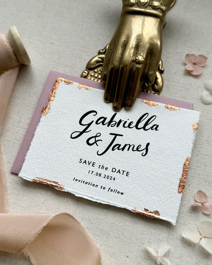 Wedding Save The Date. Beautiful calligraphy names read Gabriella & James with  wedding date below. Printed onto tactile Indian handmade cotton paper. The cards have hand torn edges for a romantic feel with copper leaf accents which sparkle.  Paired with a dusty pink coloured envelope. Fancy Folk