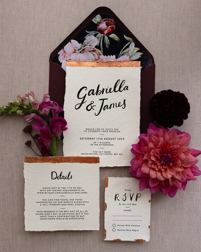 Modern Calligraphy Wedding Invitation, Details Card and RSVP with rich burgundy coloured envelopes. Our wedding stationery features a beautiful hand lettered calligraphy names design printed on textured handmade Indian paper with hand torn edges for a soft romantic feel. Each piece is lovingly hand finished with copper leaf for a luxury feel. Styled with burgundy and coral florals, perfect for autumn and winter weddings. Fancy Folk