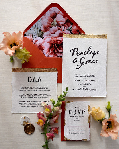 Modern Calligraphy Wedding Invitation, Details Card and RSVP with terracotta  coloured envelopes. Our wedding stationery features a beautiful hand lettered calligraphy names design printed on textured handmade Indian paper with hand torn edges for a soft romantic feel. Each piece is lovingly hand finished with gold leaf for a luxury feel. Styled with white and gold leaf wax seals and peachy florals. Fancy Folk