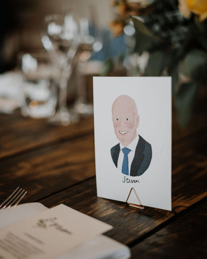 Illustrated wedding portrait of your guests used as a table place cards. Surrounded by florals. Fancy Folk.