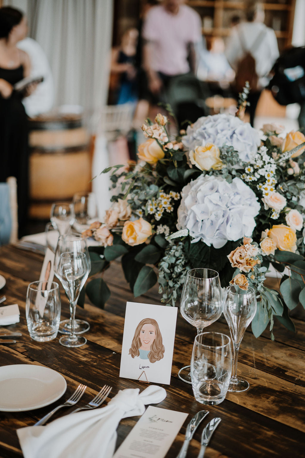 Illustrated wedding portrait used as a table place card. Surrounded by florals. Fancy Folk.