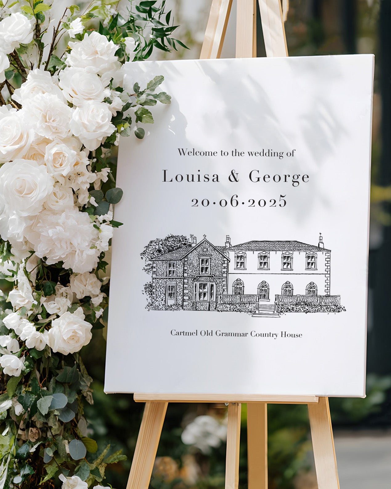 wedding venue illustrated in a line drawing style printed on a large welcome board. Placed on an easel with chic white florals. Fancy Folk