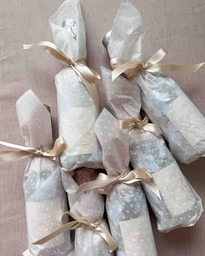 Set of mini bottles with hand painted blue florals and personalised  labels. Beautifully gift wrapped in white spotty tissue paper and ties with a ribbon.