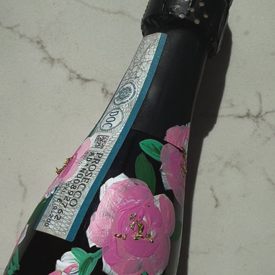 Hand painted pink roses with gold leaf accents in the centres. Painted onto mini bottles of Prosecco. a perfect bridesmaids proposal gift. Fancy Folk Design