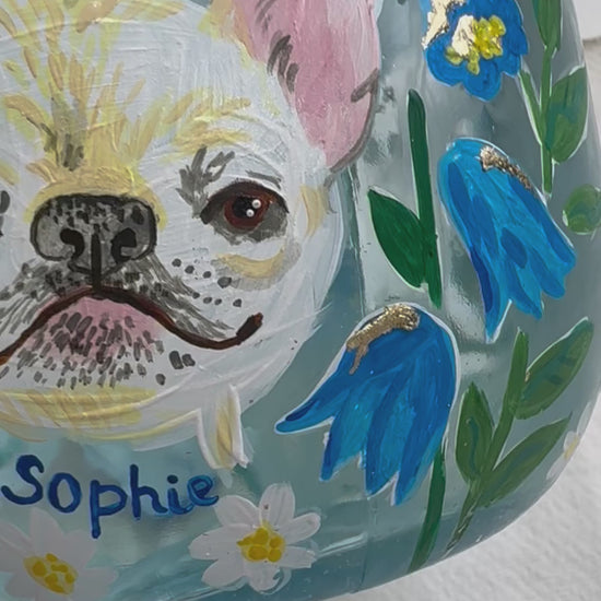 Hand painted pet portrait of a cute french bulldog on a celebration bottle of   alcohol. A pale blue bottle is decorated with beautiful blue florals and calligraphy pets name. Finished with accents of gold leaf. Perfect personalised gift. Fancy Folk