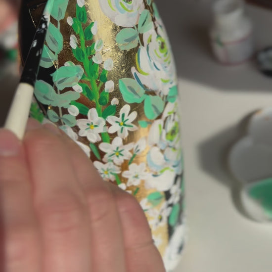 Hand painted Champagne bottle. A video of flowers and eucalyptus being painted onto a gold leaf base. Fancy Folk