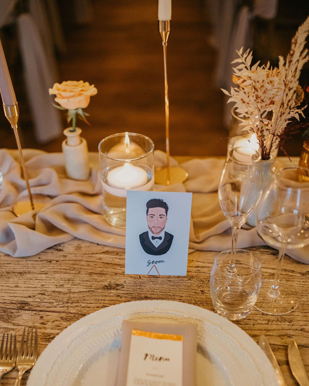 Illustrated wedding portrait of the groom uses as a table place card. Surrounded by boho florals. Fancy Folk.