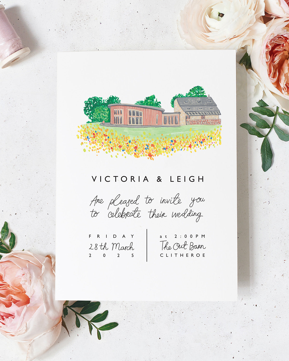 Wedding venue illustration of The Out Barn in Clitheroe as the focal feature on a wedding invitation. A beautiful round barn building nestled in a wildflower meadow. A perfect wedding or anniversary gift, hand painted and framed. Fancy Folk.